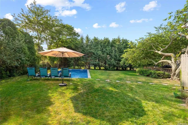a backyard of a house with table and chairs