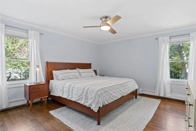 a large bed sitting in a bedroom next to a window