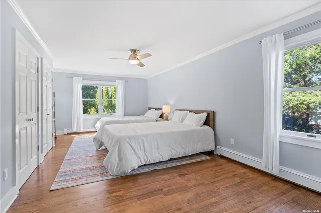 a spacious bedroom with a bed and a window