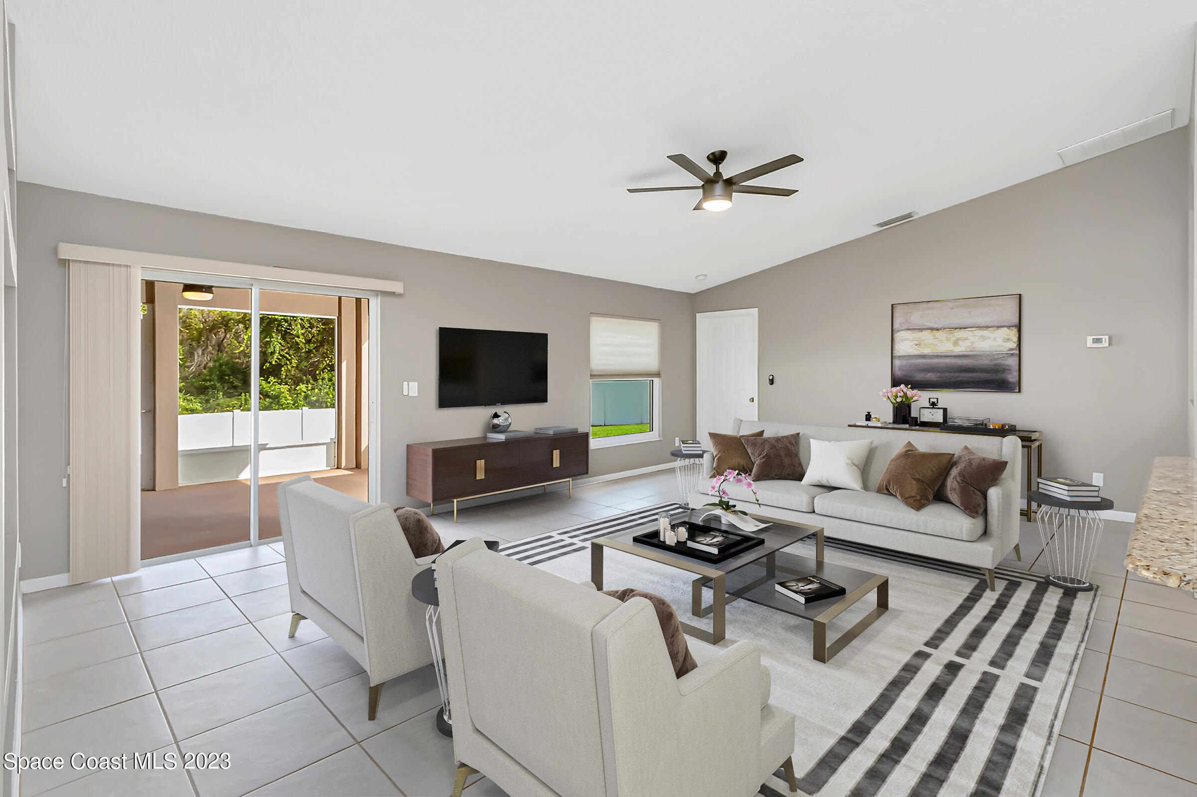 4181 Long Leaf Drive Melbourne, FL 32940 - Photo 10 of 37 a living room with furniture a flat screen tv and a window