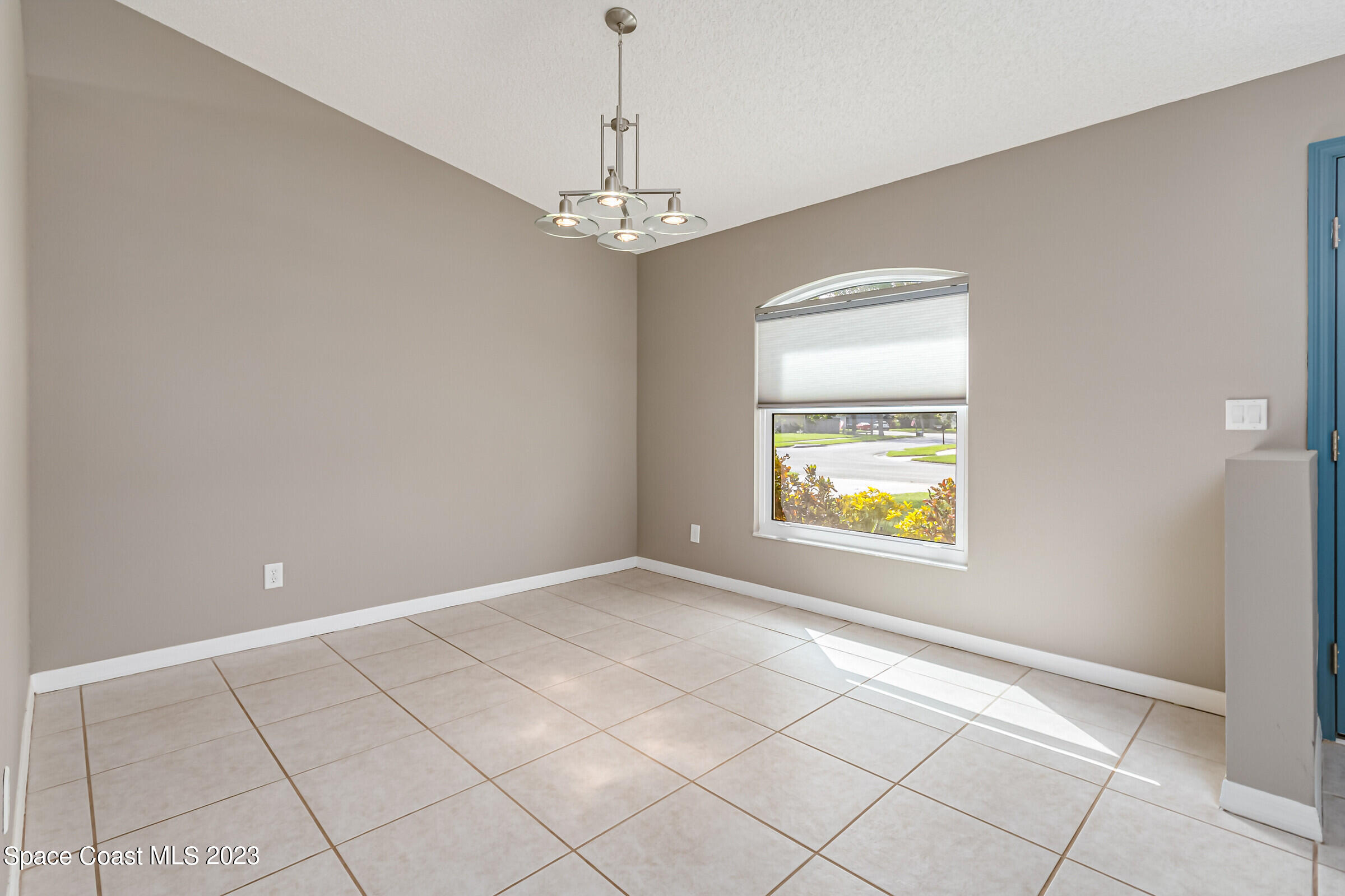4181 Long Leaf Drive Melbourne, FL 32940 - Photo 16 of 37 a view of an empty room with window and chandelier fan