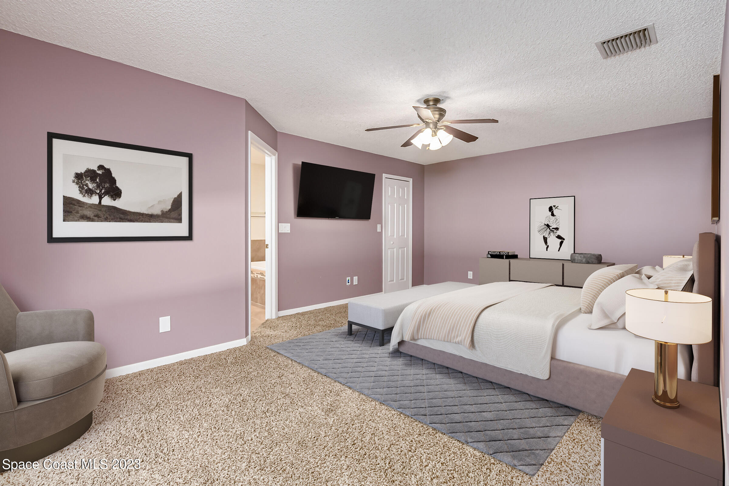 4181 Long Leaf Drive Melbourne, FL 32940 - Photo 19 of 37 a spacious bedroom with a bed and a couch