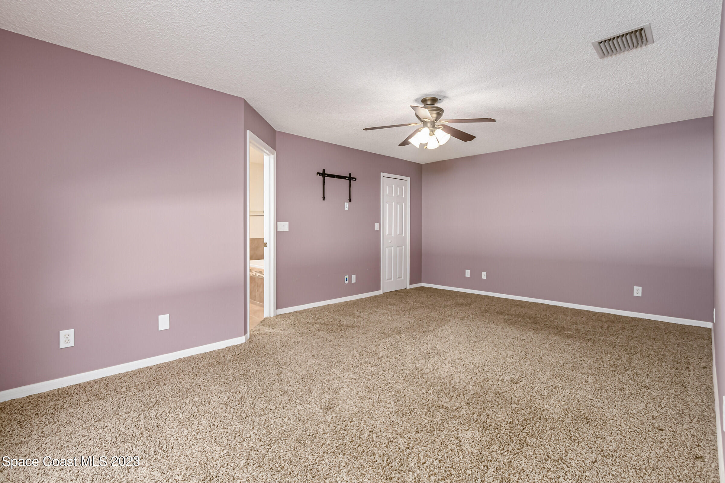 4181 Long Leaf Drive Melbourne, FL 32940 - Photo 20 of 37 a view of an empty room with a chandelier fan