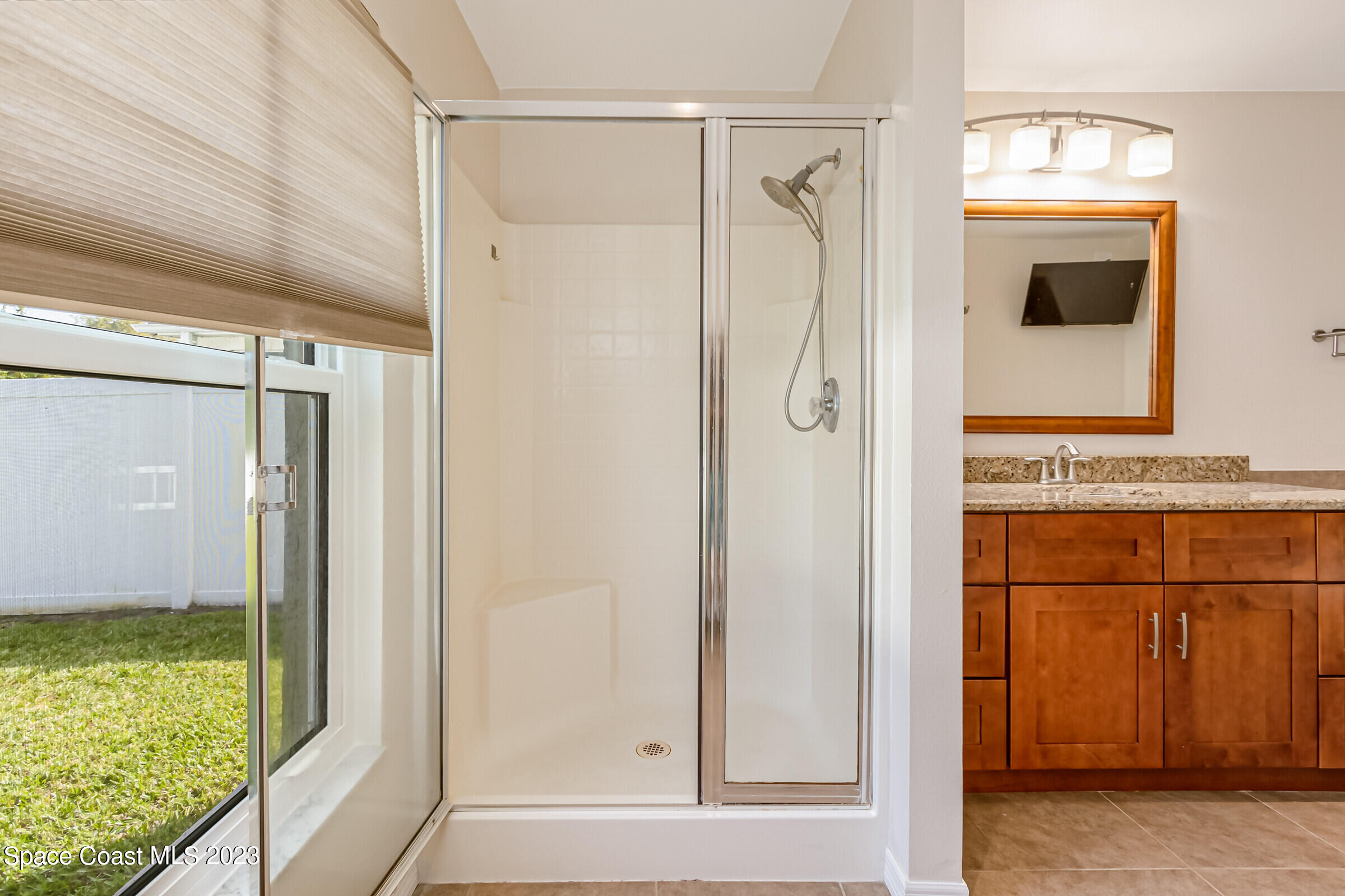 4181 Long Leaf Drive Melbourne, FL 32940 - Photo 24 of 37 a bathroom with a shower and a mirror