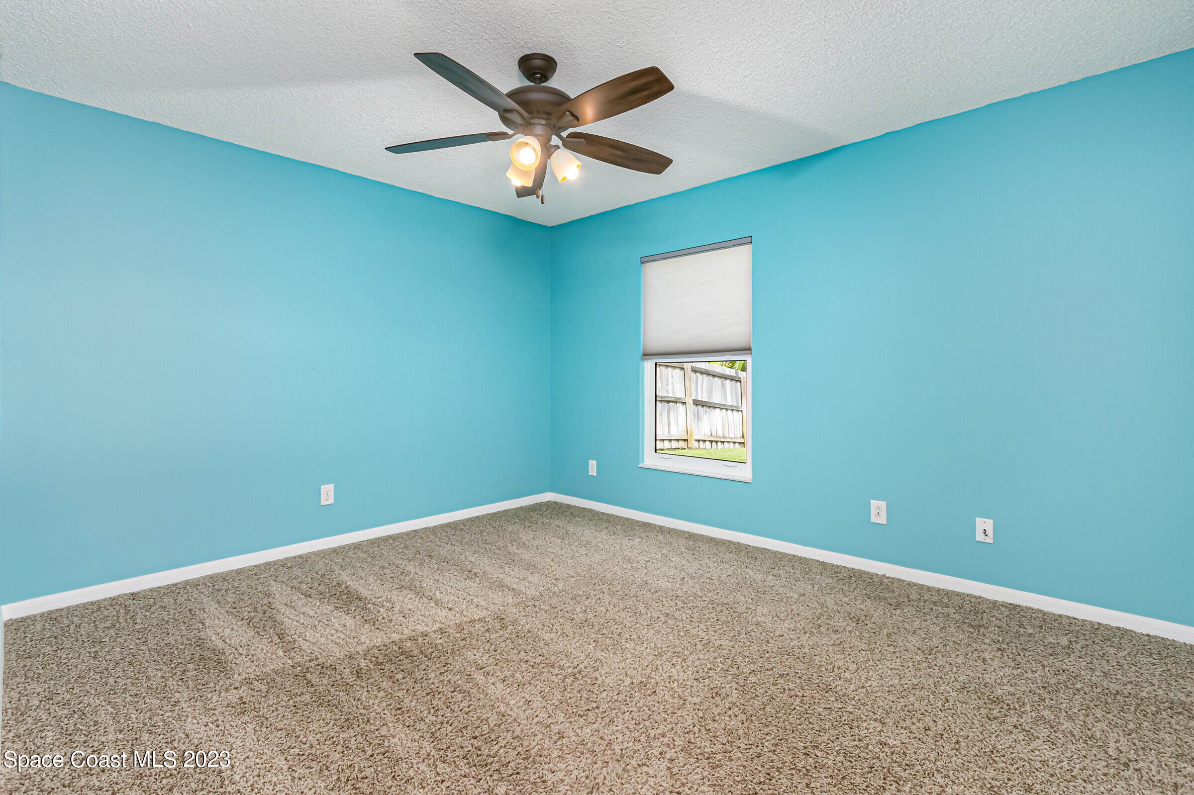 4181 Long Leaf Drive Melbourne, FL 32940 - Photo 26 of 37 an empty room with a window and a fan