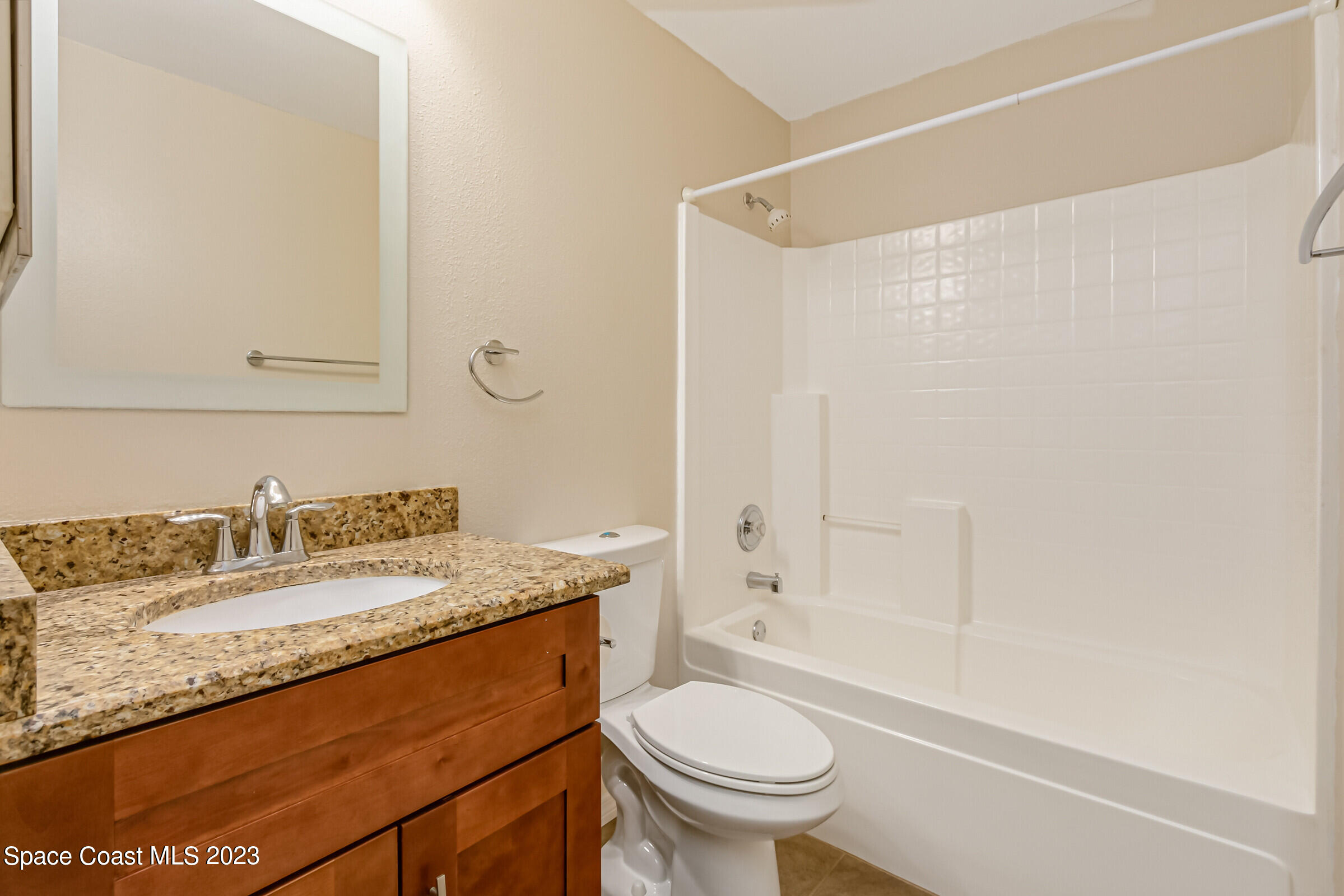4181 Long Leaf Drive Melbourne, FL 32940 - Photo 27 of 37 a bathroom with a granite countertop sink toilet and shower