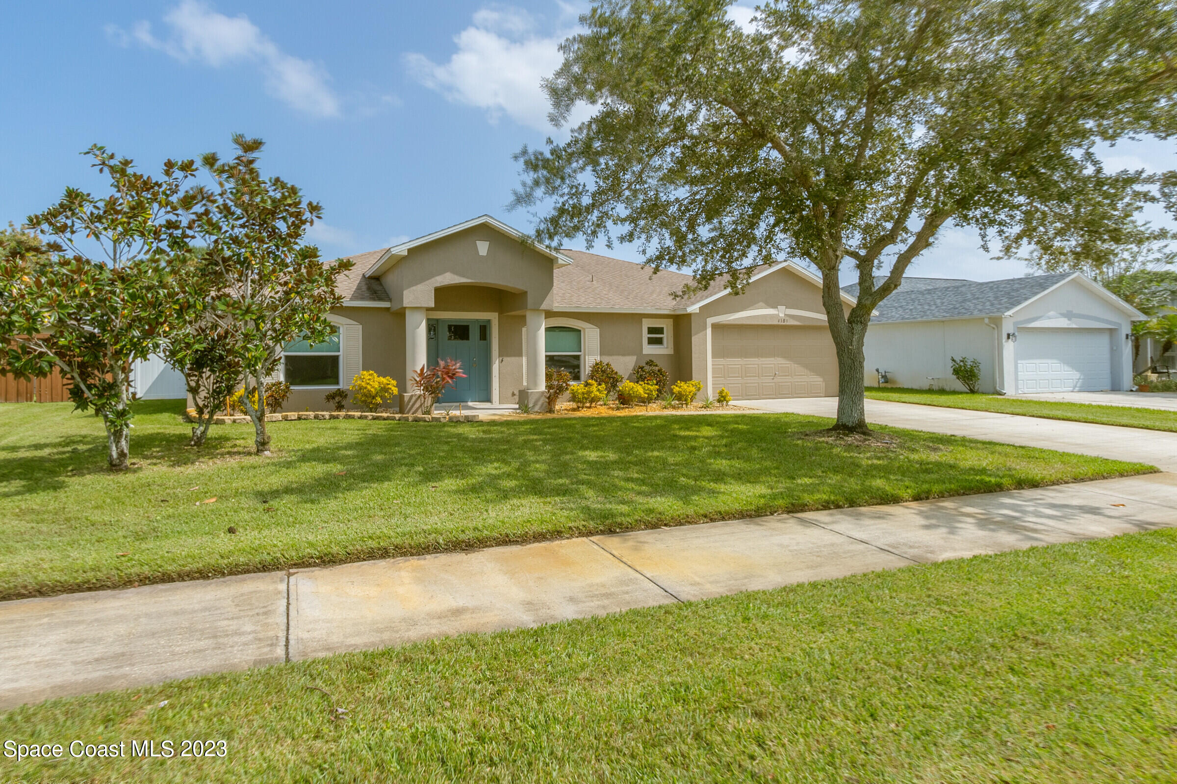 4181 Long Leaf Drive Melbourne, FL 32940 - Photo 3 of 37 a front view of a house with a yard