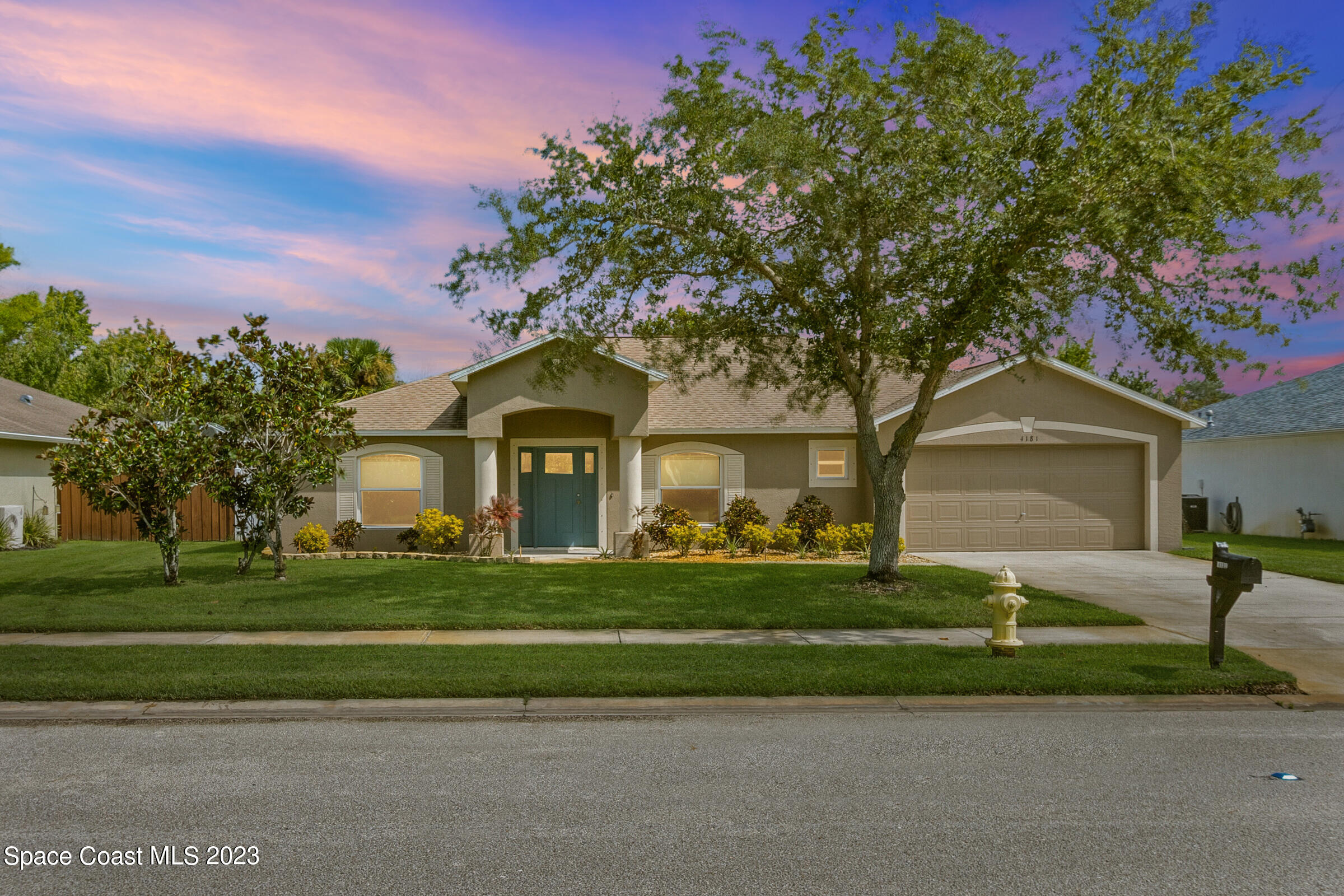 4181 Long Leaf Drive Melbourne, FL 32940 - Photo 34 of 37 a front view of a house with a yard and trees