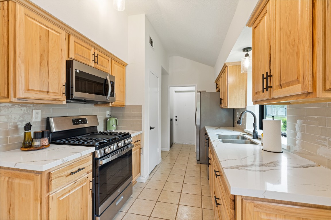 9719 Orangevale Drive Spring, TX 77379 - Photo 11 of 32 Another image of kitchen highlighting the attractive cabinets offering plenty of storage. Kitchen also includes good sized pantry and convenient entrance to utility room and garage.