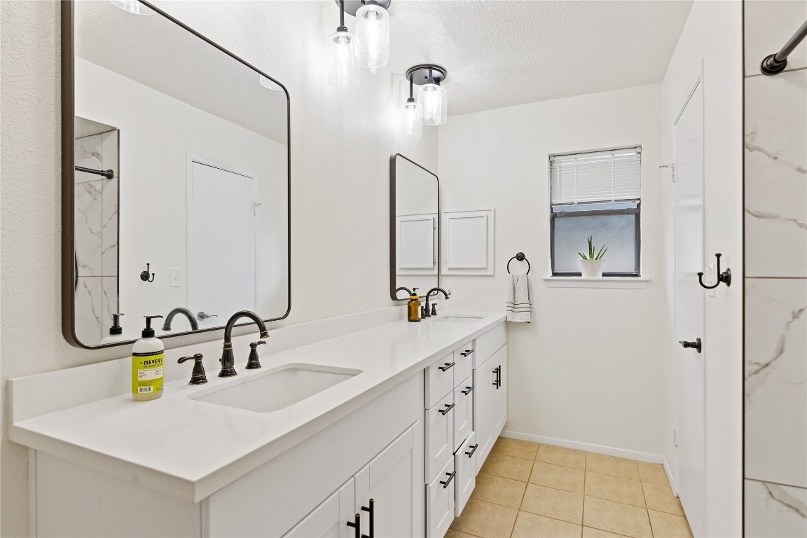 9719 Orangevale Drive Spring, TX 77379 - Photo 19 of 32 Another image of large primary bathroom with attractive quartz counters with dual sinks as well as attractive lighting and mirrors.