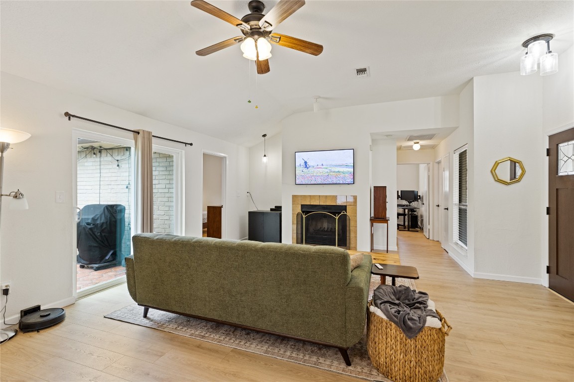 9719 Orangevale Drive Spring, TX 77379 - Photo 6 of 32 Large attractive den highlighted by fireplace and beautiful wood flooring.