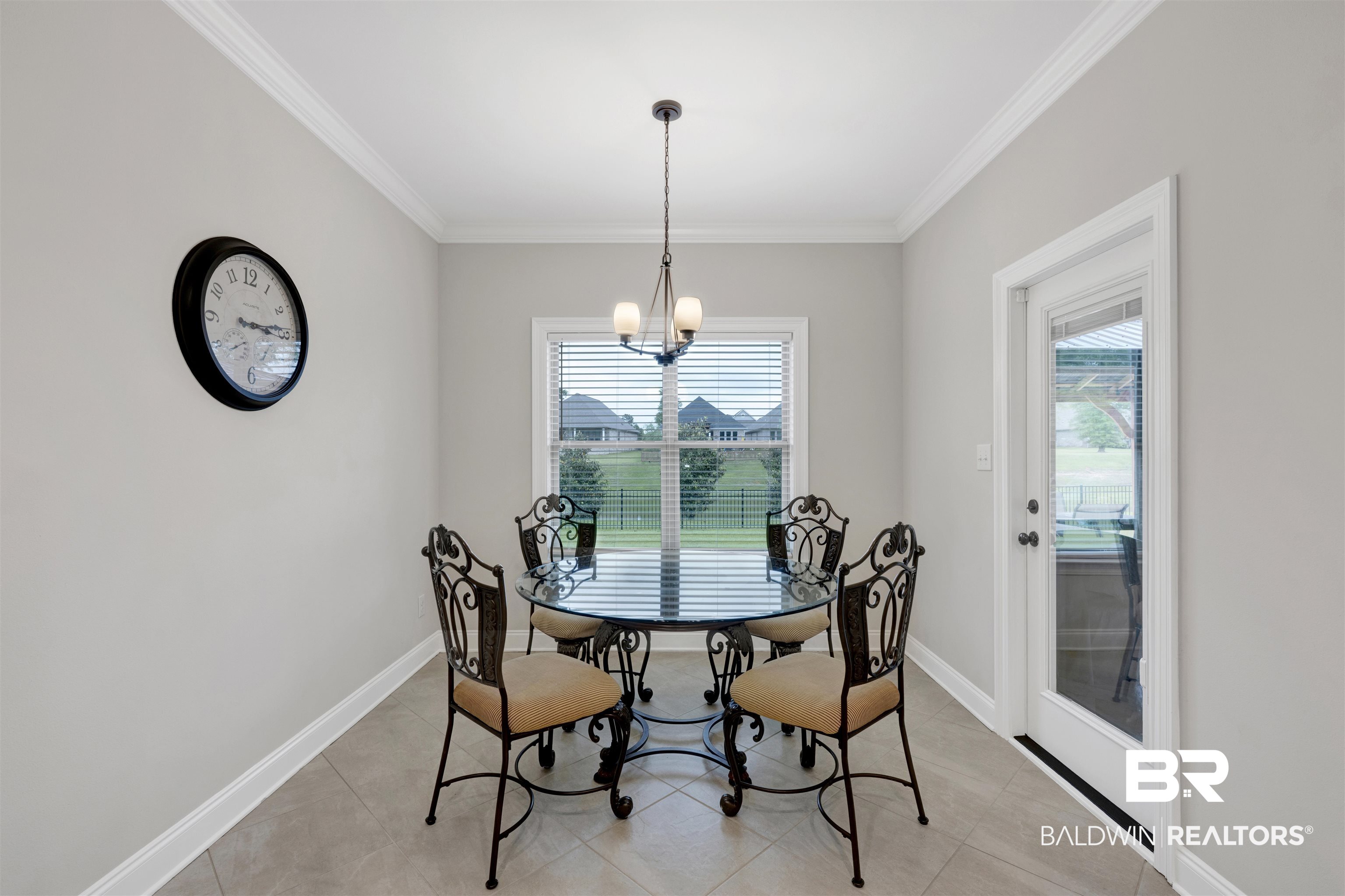 12672 Squirrel Drive Daphne, AL 36527 - Photo 15 of 49 Dining area with light gray walls, tile flooring, and white crown molding