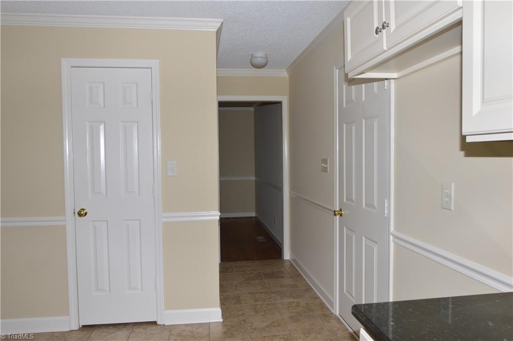 5000 Peppertree Road Clemmons, NC 27012 - Photo 11 of 30 Pantry door, entrance to formal dining, door to garage
