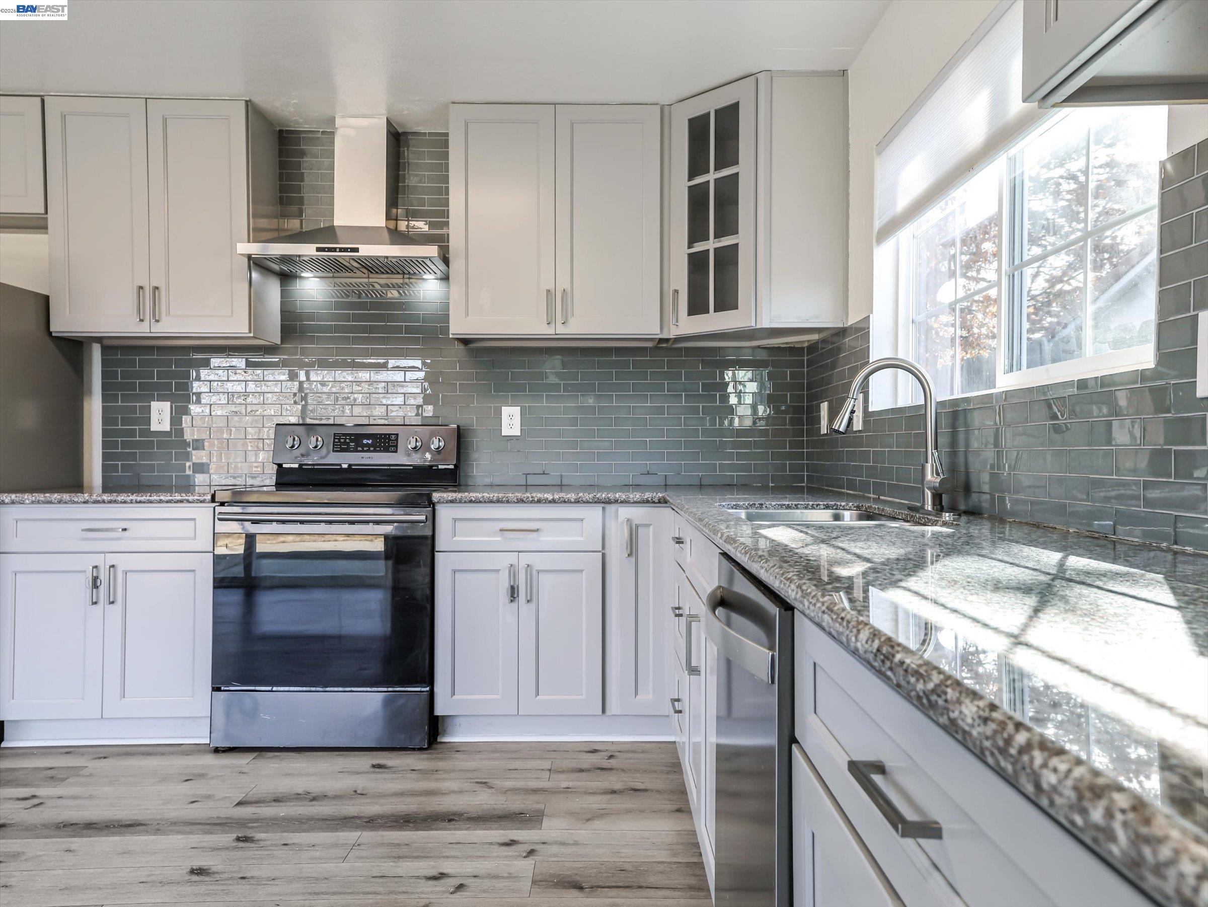 3432 Danielle Place Bay Point, CA 94565 - Photo 12 of 36 a kitchen with granite countertop a sink stove and cabinets