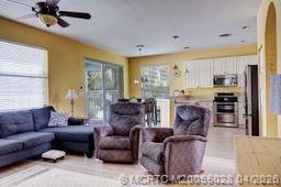 2120 Northwest Marsh Rabbit Lane Jensen Beach, FL 34957 - Photo 14 of 34 a living room with furniture and a large window