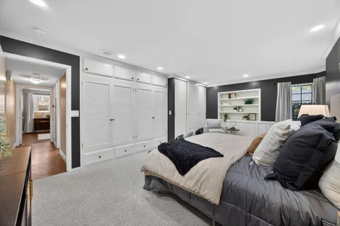 a large bedroom with a bed and a large mirror