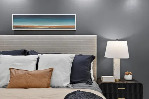 a bedroom with a bed and a lamp