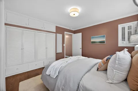 a bedroom with a bed and a chair