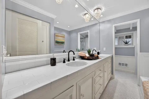 a bathroom with a double vanity sink a mirror and a bathtub