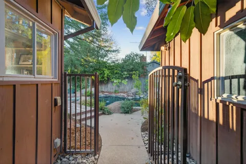 a view of balcony with wooden floor and fence