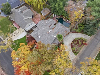 an aerial view of a house with a yard