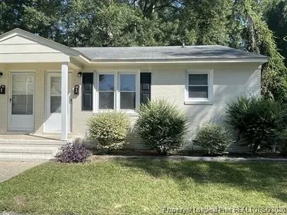 a front view of a house with garden