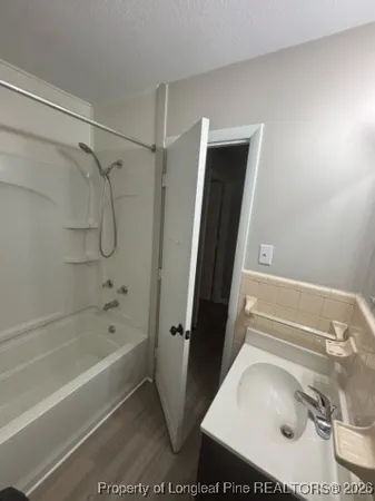 a bathroom with a tub and a shower