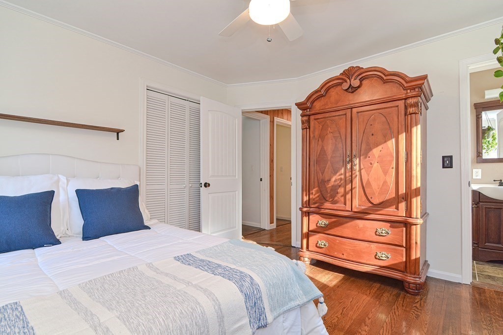 21 Coolidge Street Sherborn, MA 01770 - Photo 12 of 41 a bedroom with a bed and wooden floor
