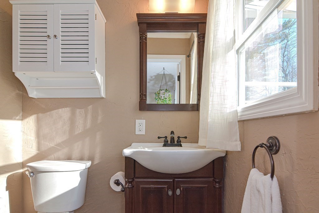 21 Coolidge Street Sherborn, MA 01770 - Photo 13 of 41 a bathroom with a sink a toilet and a mirror