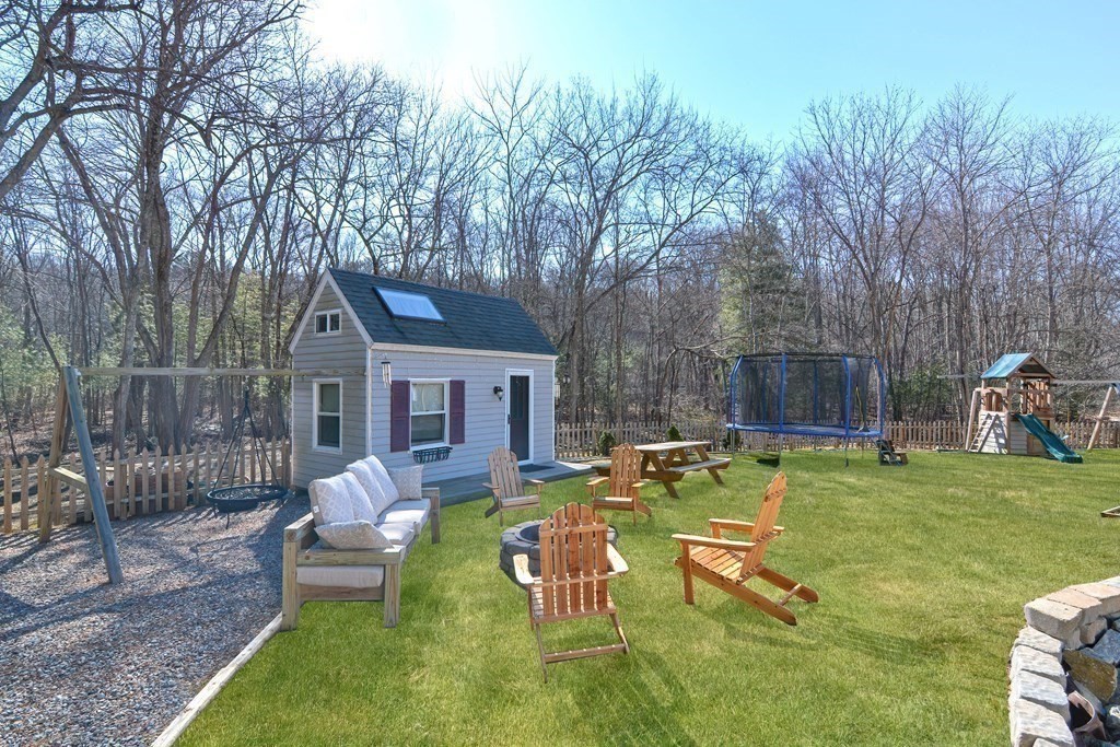 21 Coolidge Street Sherborn, MA 01770 - Photo 4 of 41 a view of a house with backyard and a chairs