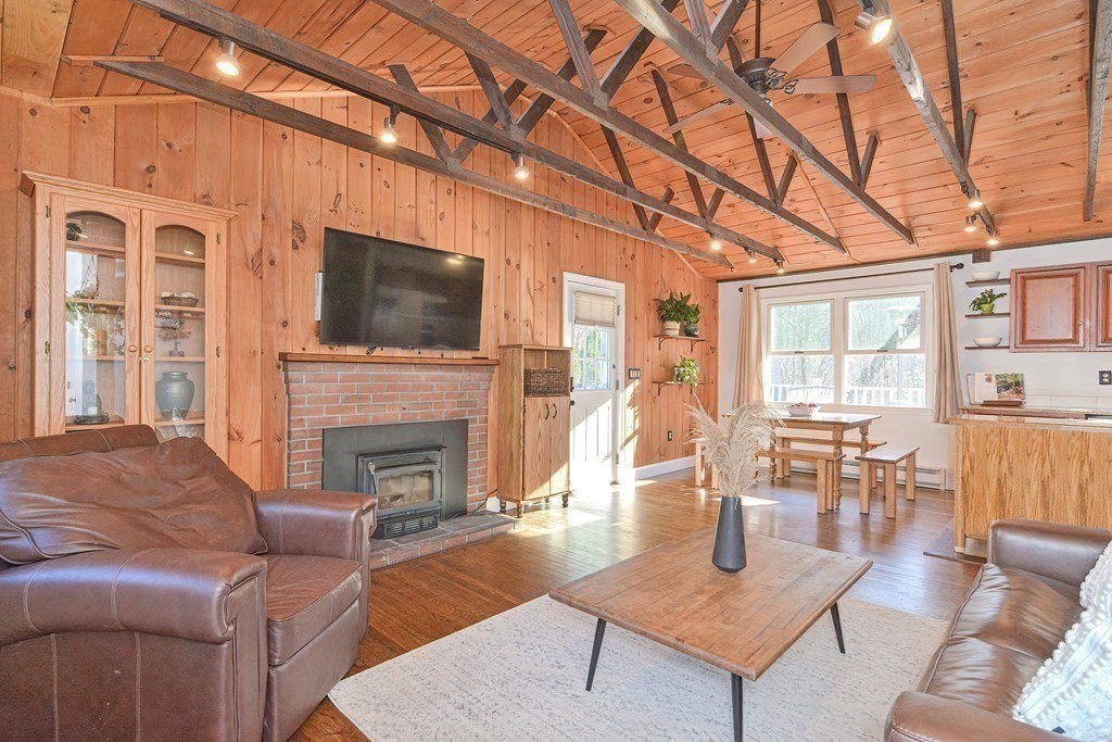 21 Coolidge Street Sherborn, MA 01770 - Photo 6 of 41 a living room with furniture a fireplace and a flat screen tv