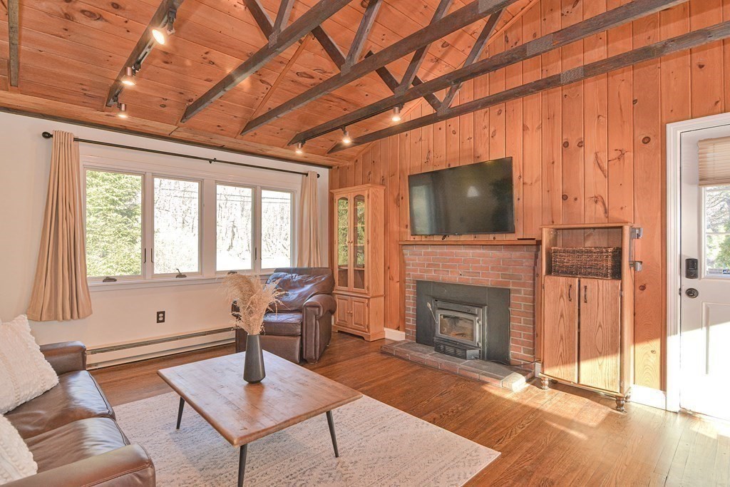 21 Coolidge Street Sherborn, MA 01770 - Photo 7 of 41 a living room with furniture a fireplace and a flat screen tv