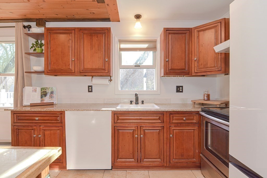 21 Coolidge Street Sherborn, MA 01770 - Photo 10 of 41 a kitchen with stainless steel appliances granite countertop a sink and cabinets