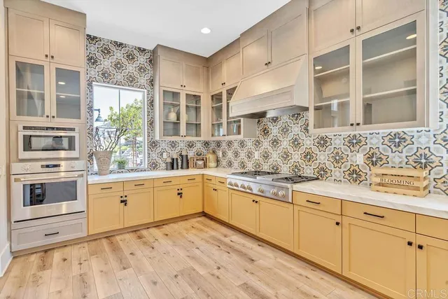 a kitchen with stainless steel appliances granite countertop a sink and cabinets