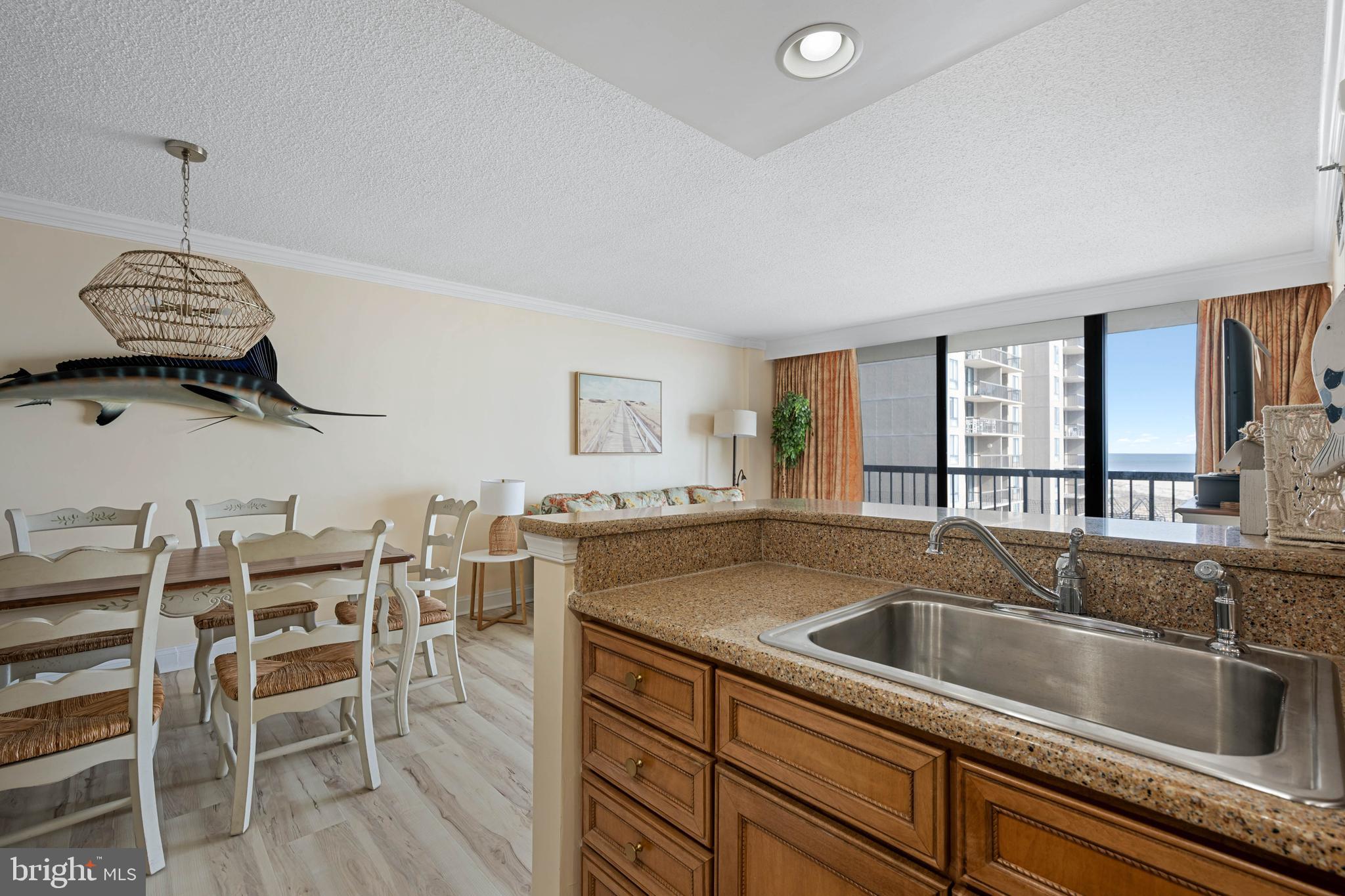 409 Georgetowne House Road Bethany Beach, DE 19930 - Photo 11 of 37 a kitchen with a sink cabinets and window
