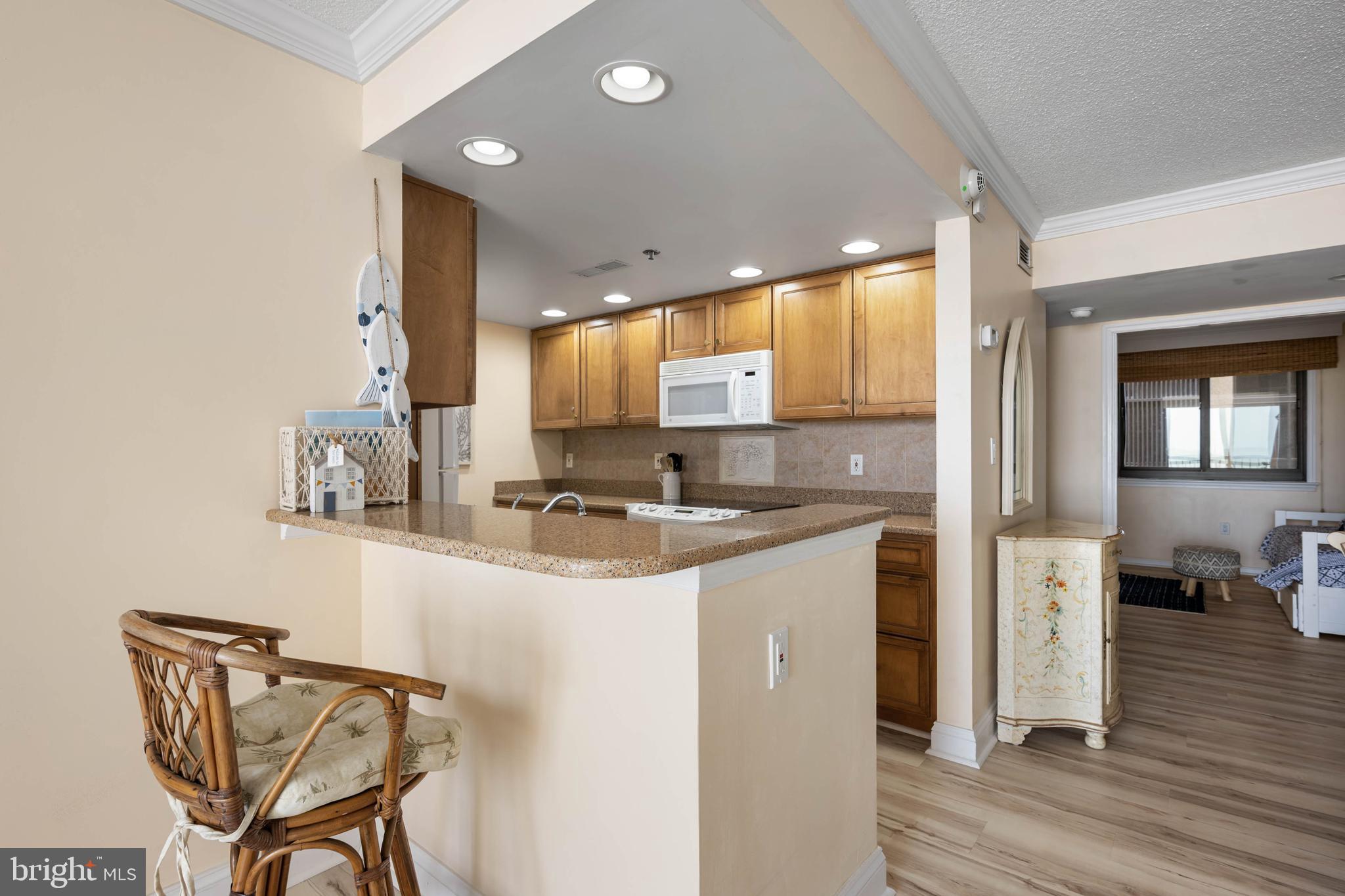 409 Georgetowne House Road Bethany Beach, DE 19930 - Photo 12 of 37 a kitchen with stainless steel appliances granite countertop a sink and cabinets