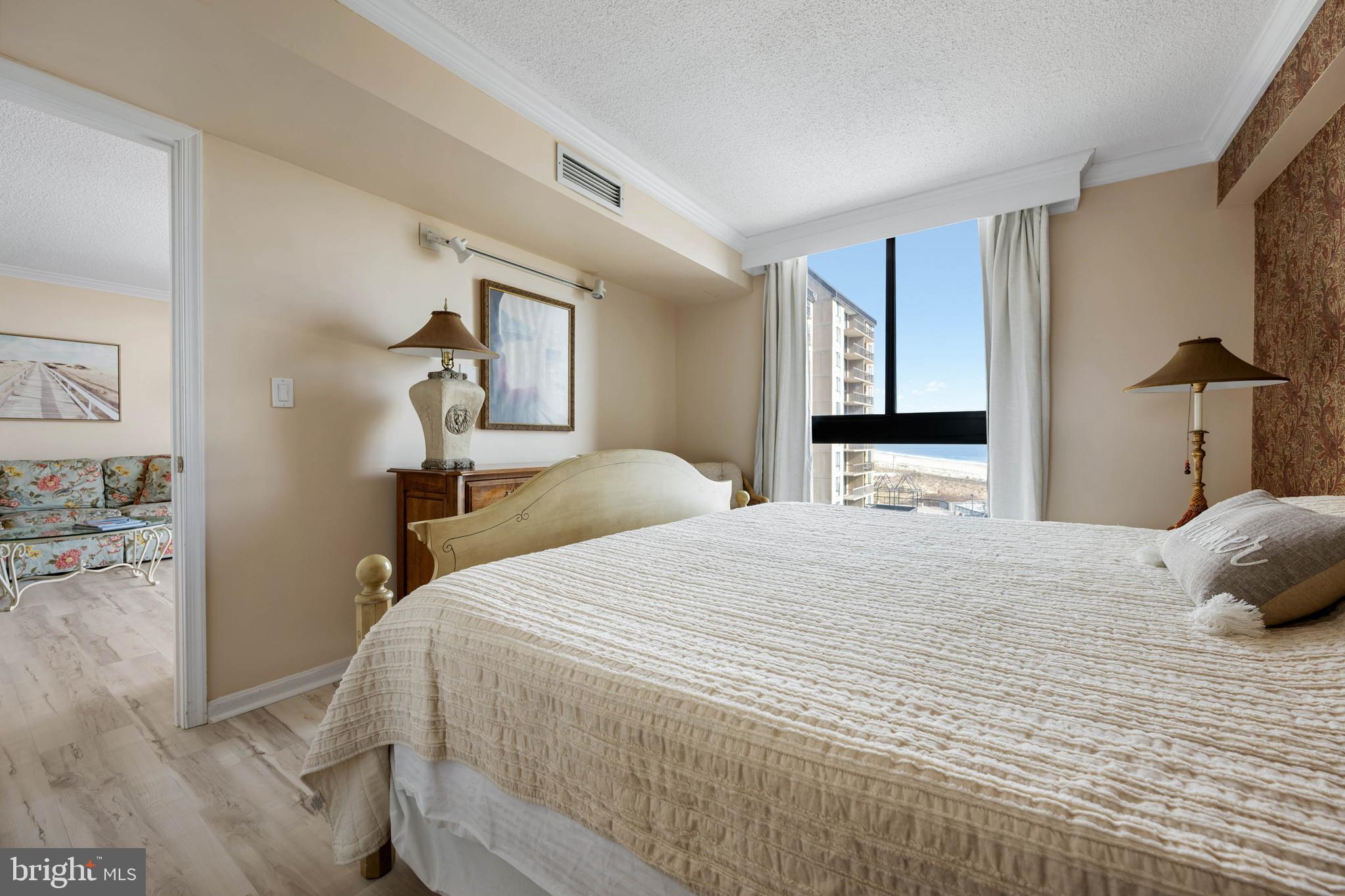 409 Georgetowne House Road Bethany Beach, DE 19930 - Photo 14 of 37 a bedroom with a bed and a large mirror