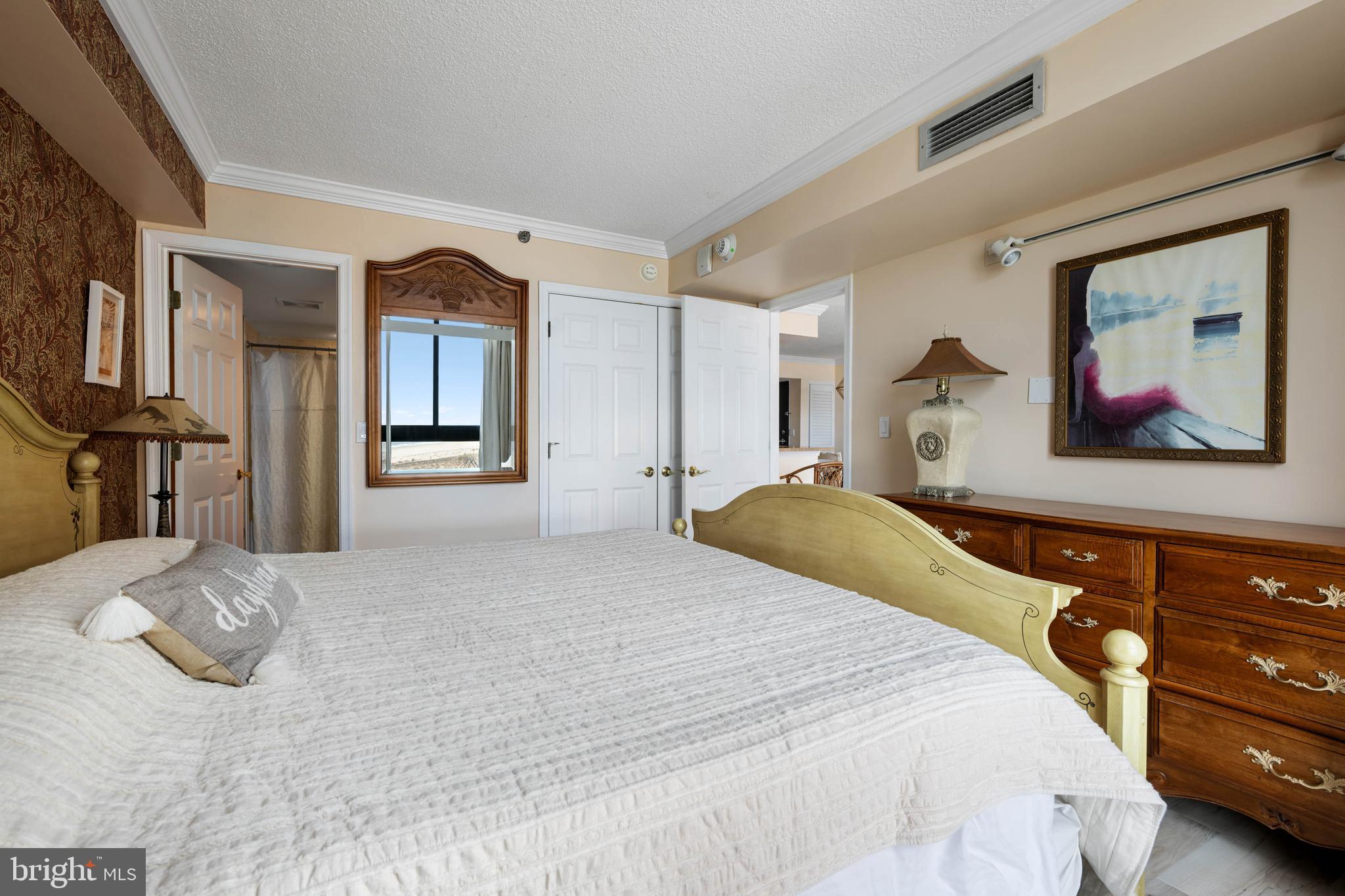 409 Georgetowne House Road Bethany Beach, DE 19930 - Photo 16 of 37 a bedroom with a bed and a painting on the wall