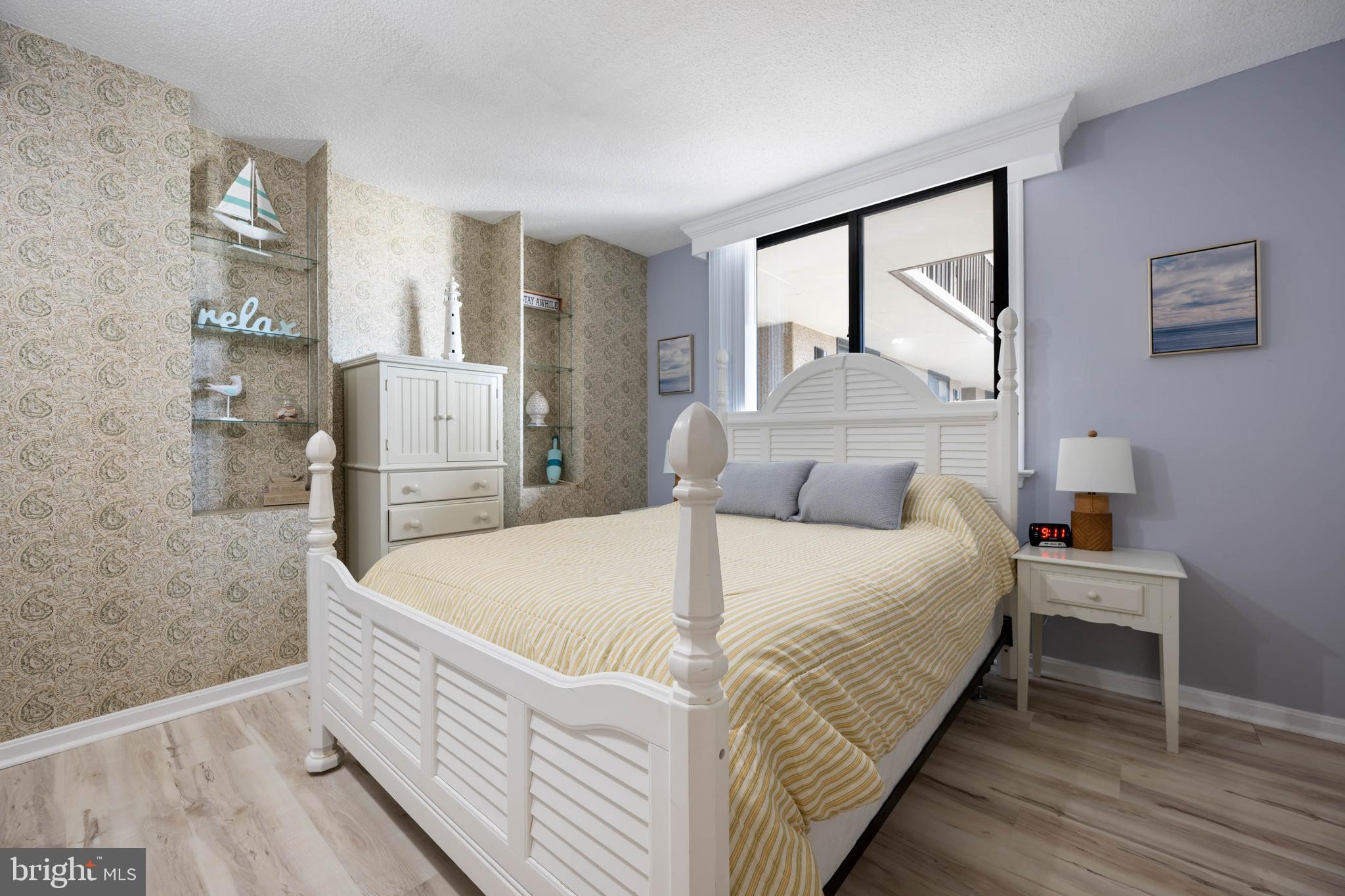 409 Georgetowne House Road Bethany Beach, DE 19930 - Photo 18 of 37 a bed sitting in a spacious bedroom next to a window