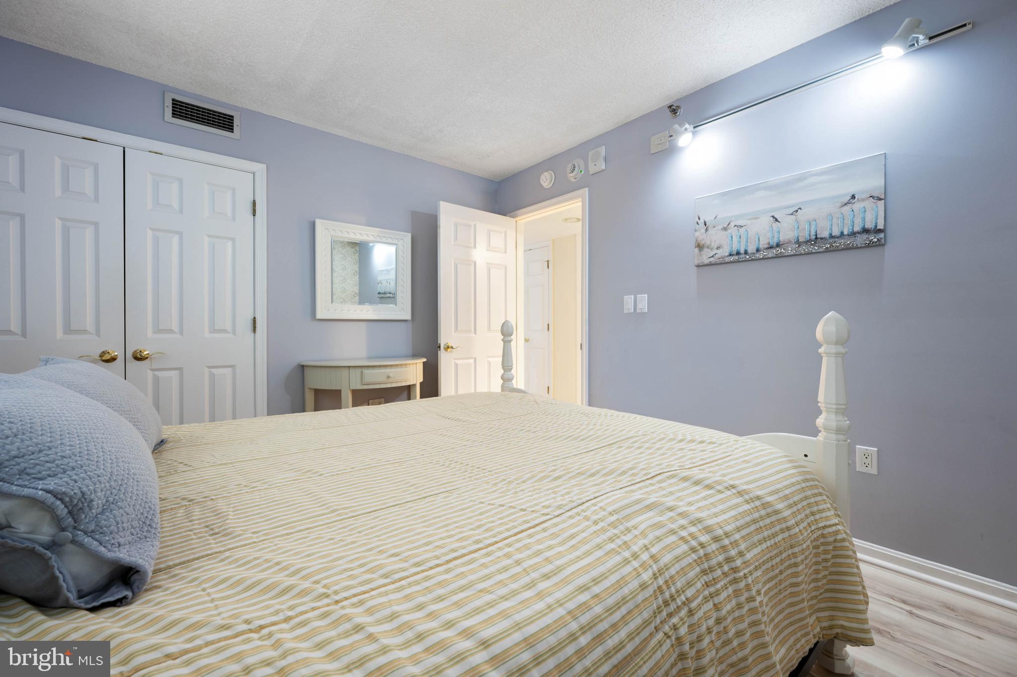 409 Georgetowne House Road Bethany Beach, DE 19930 - Photo 19 of 37 a bedroom with a bed and a painting