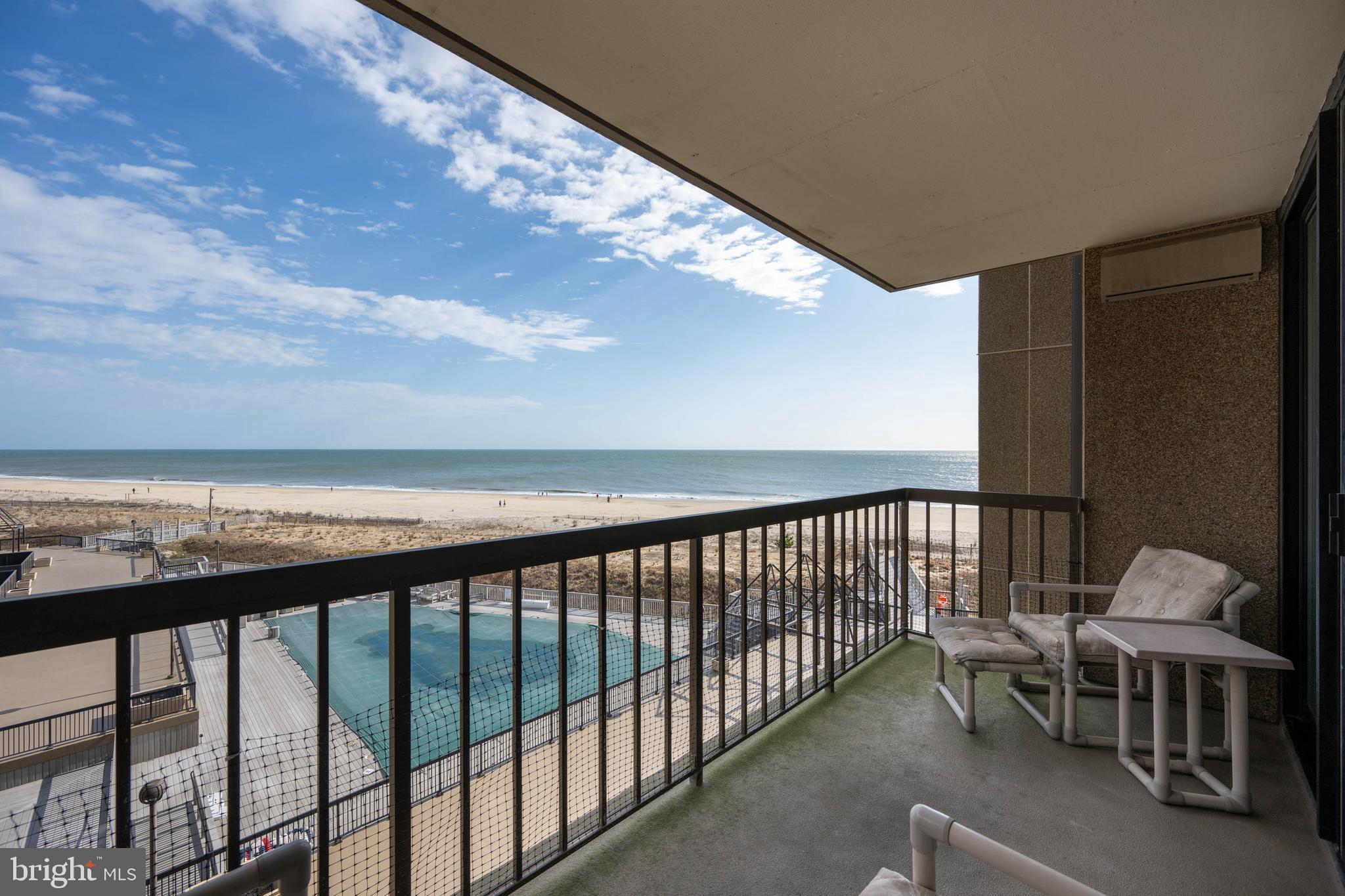 409 Georgetowne House Road Bethany Beach, DE 19930 - Photo 2 of 37 a balcony with table and chairs