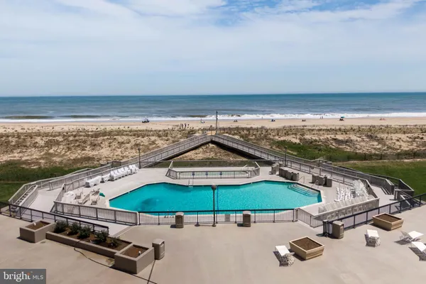 a view of swimming pool with outdoor seating