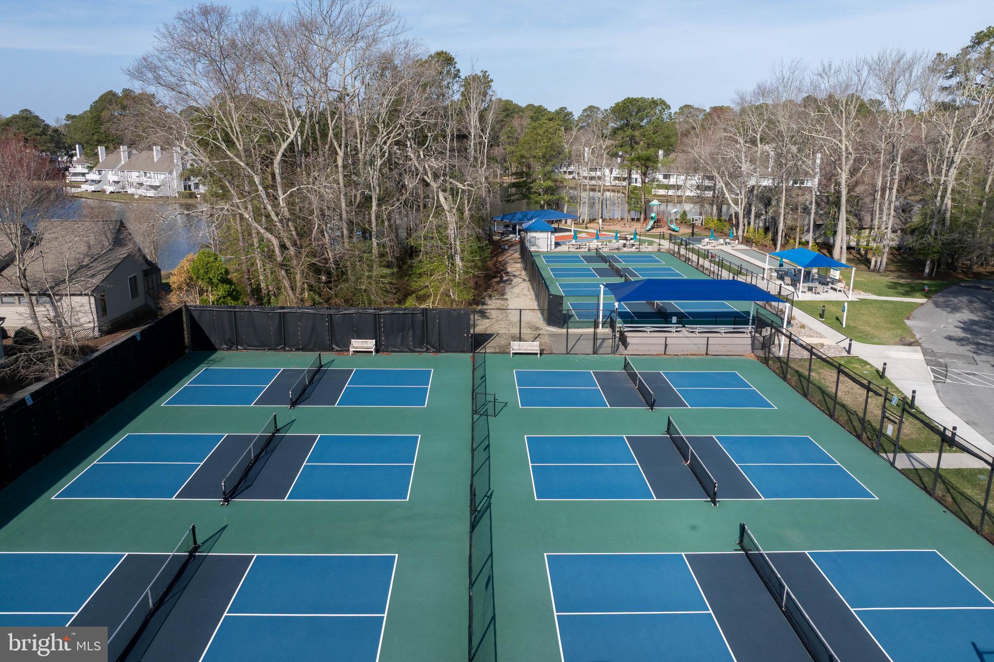 409 Georgetowne House Road Bethany Beach, DE 19930 - Photo 28 of 37 a backyard of a house with table and chairs