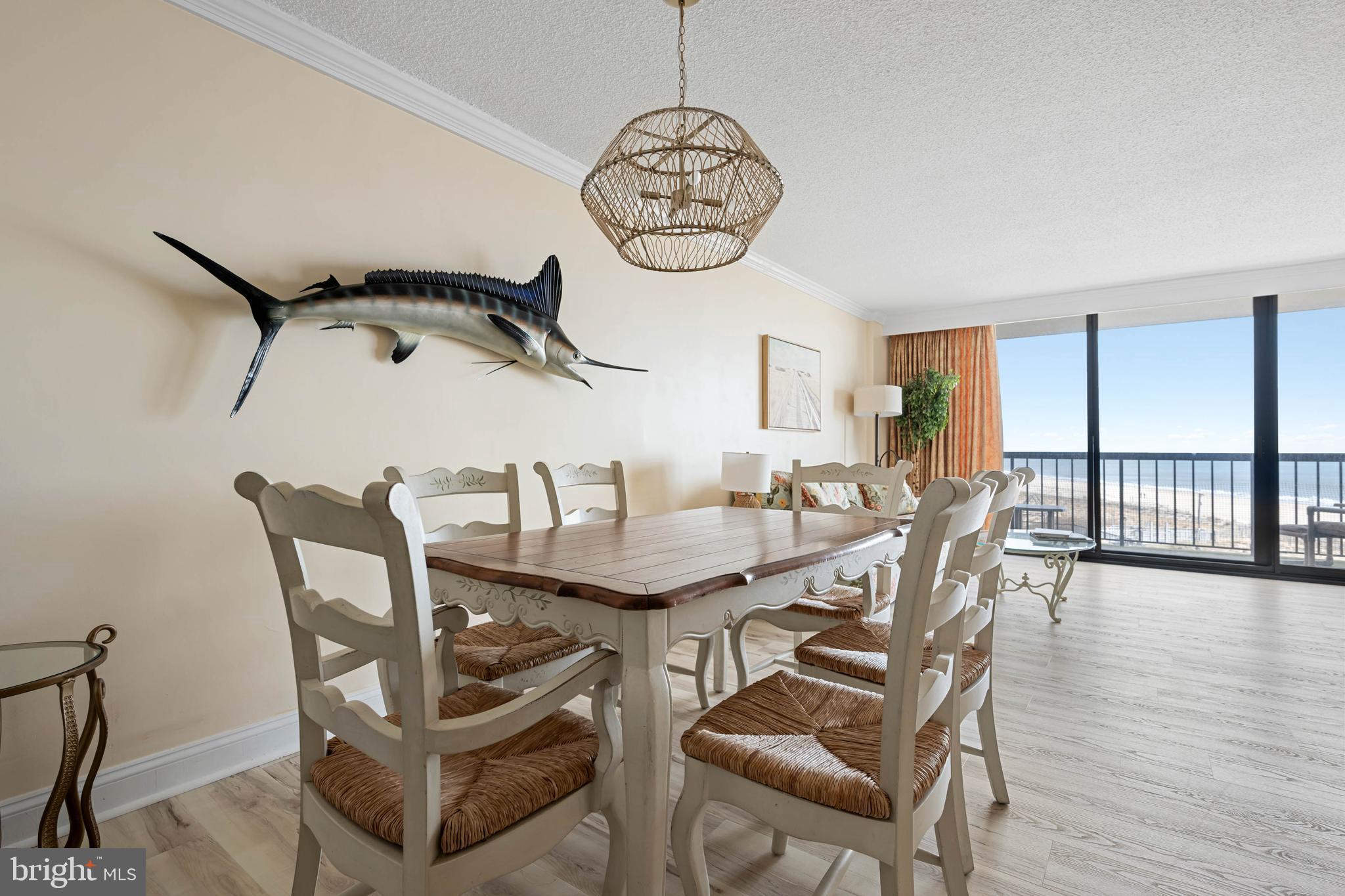 409 Georgetowne House Road Bethany Beach, DE 19930 - Photo 8 of 37 a view of a dining room with furniture window and wooden floor