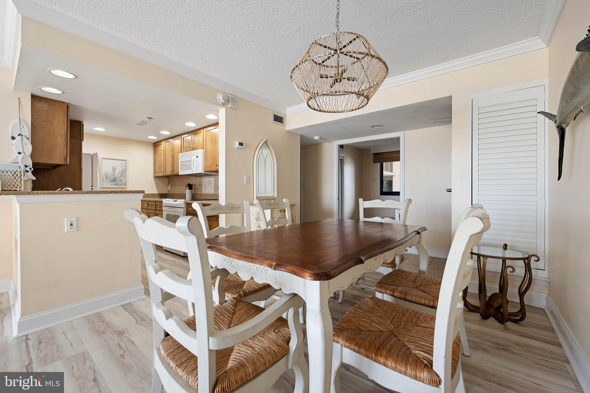 409 Georgetowne House Road Bethany Beach, DE 19930 - Photo 9 of 37 a view of a dining room with furniture and wooden floor