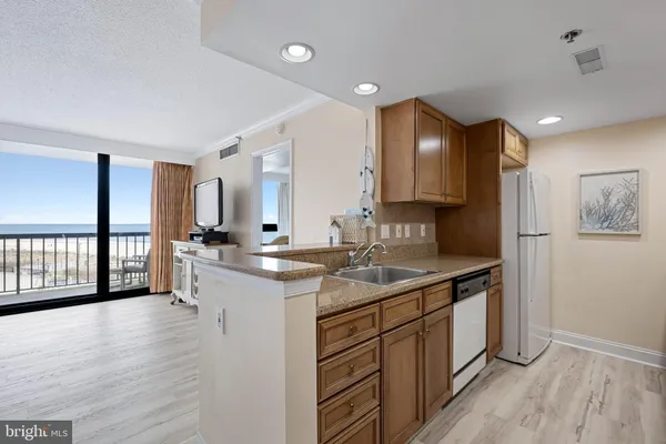 a kitchen with stainless steel appliances granite countertop a sink and cabinets