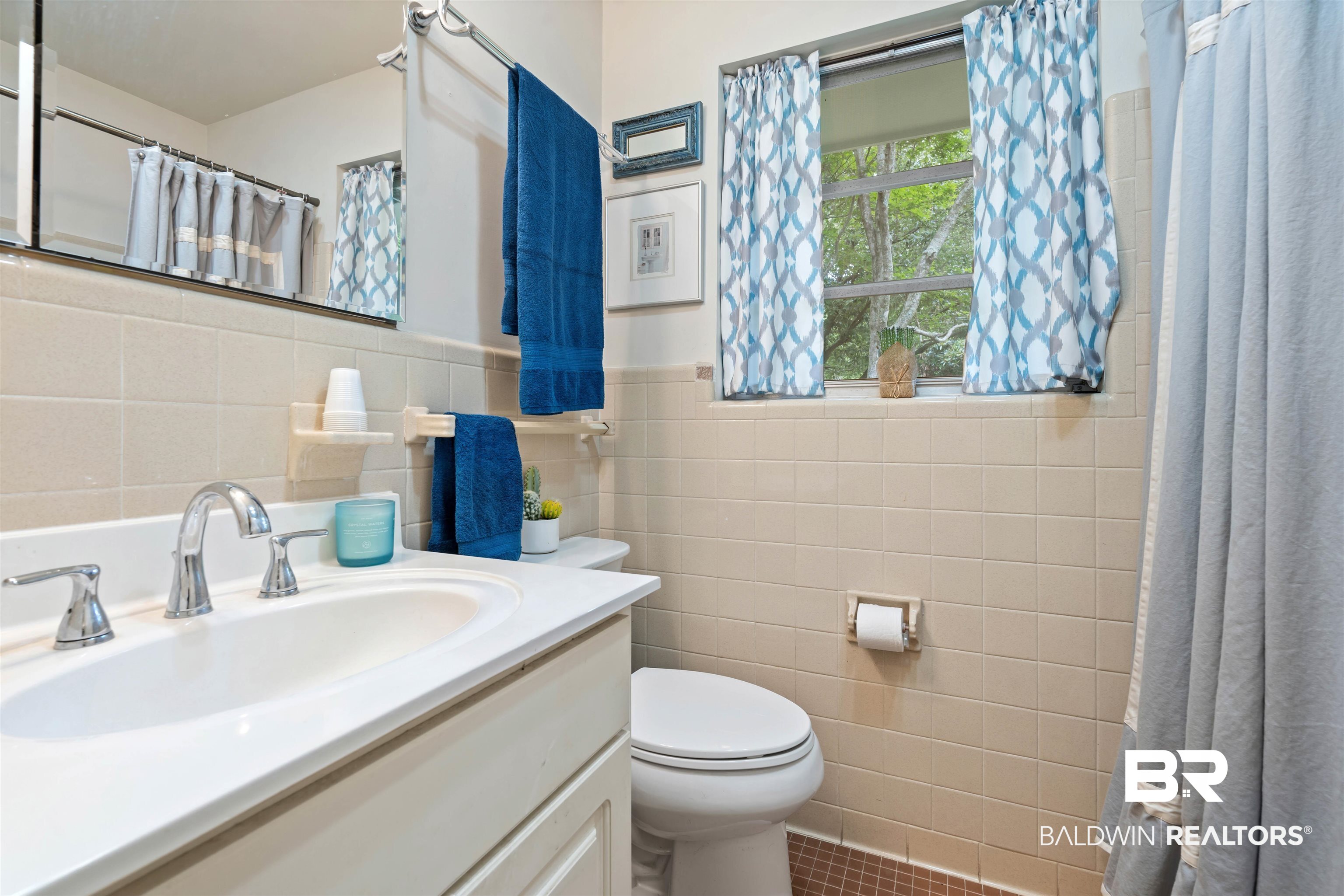 4051 East Canal Circle Mobile, AL 36619 - Photo 22 of 32 Bathroom with vanity, tile patterned floors, tasteful backsplash, tile walls, and toilet