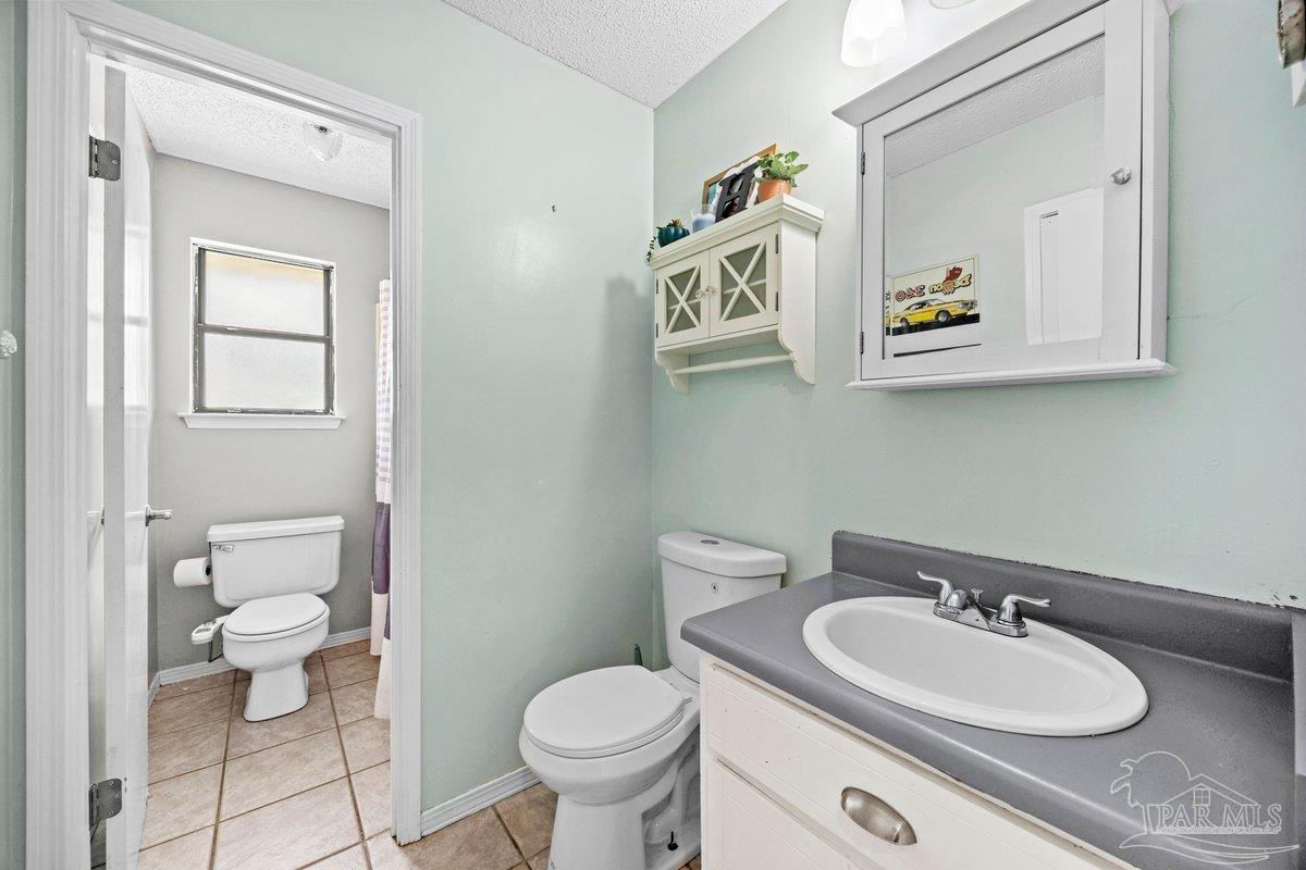 2194 Pompano Street Cantonment, FL 32533 - Photo 13 of 23 a bathroom with a sink a toilet and a mirror