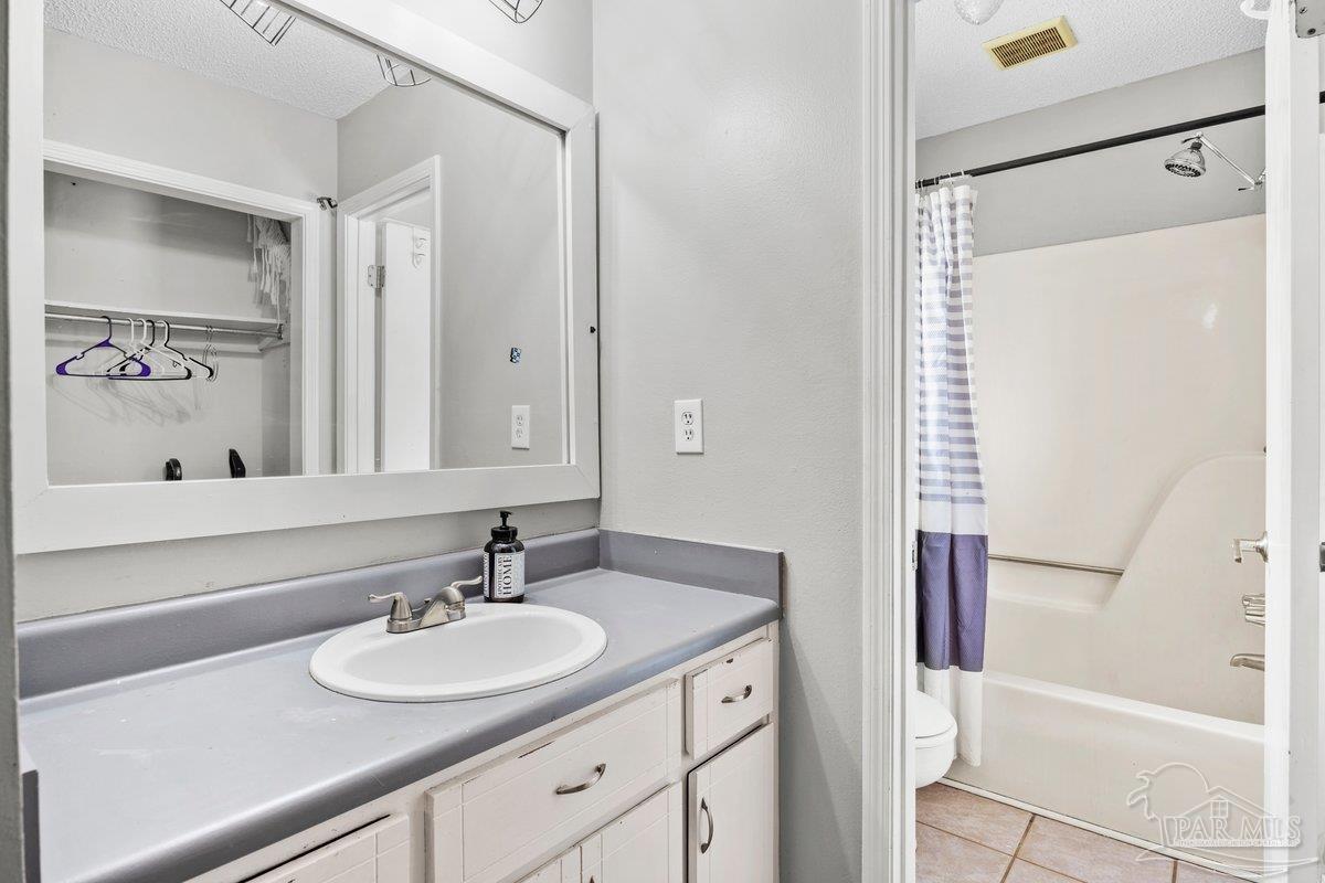 2194 Pompano Street Cantonment, FL 32533 - Photo 14 of 23 a bathroom with a sink and a mirror