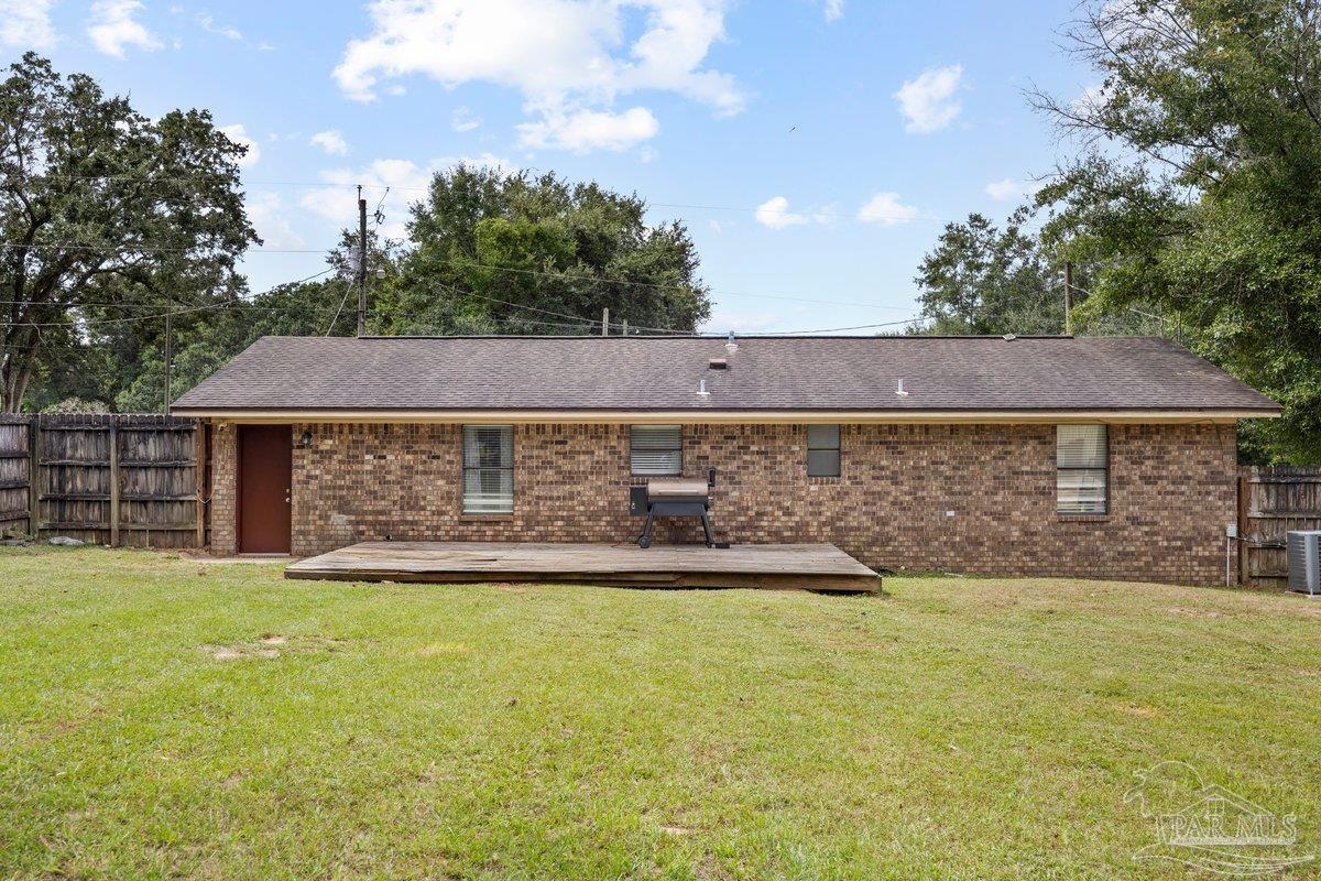 2194 Pompano Street Cantonment, FL 32533 - Photo 15 of 23 a view of a house with a yard and a large tree